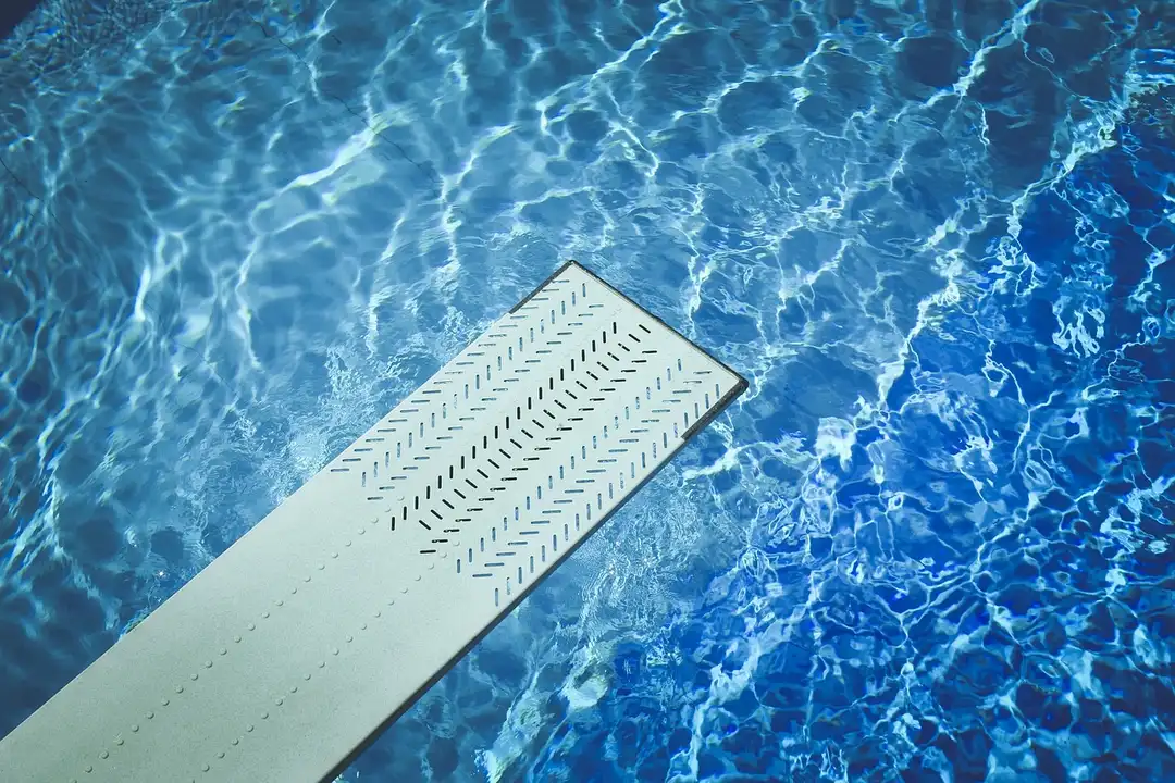 Diving board and a crystal clear pool water